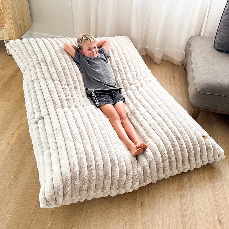 Oversized champagne bean bag mat designed for both adults and kids.