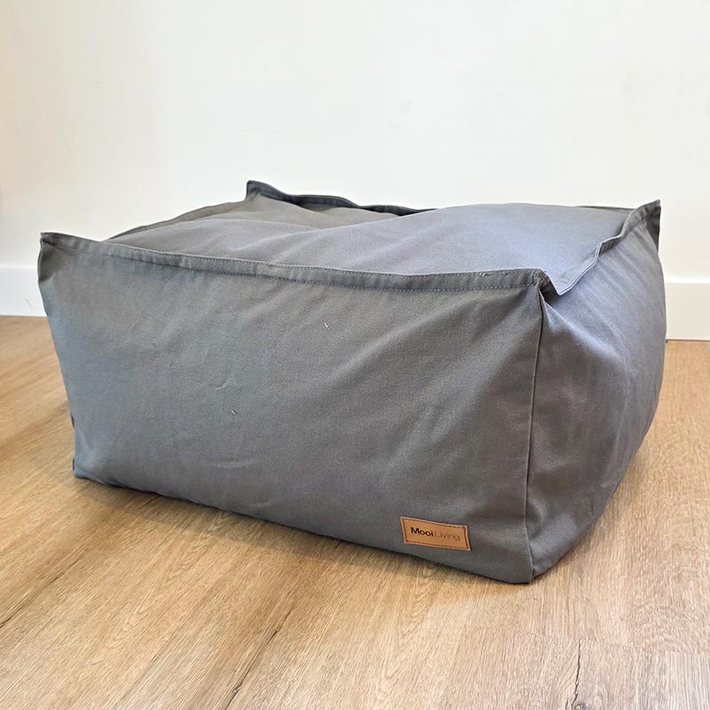 Mooi Living Mocha cotton canvas ottoman positioned in a contemporary living space.