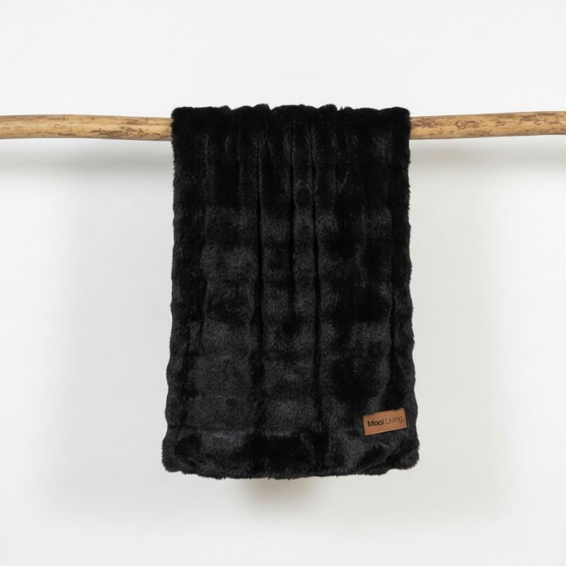 Black textured blanket with a Mooi Living brand