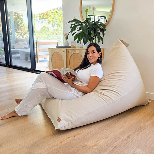 Natural Cotton Canvas Triangle indoor lounge chair, indoor bean bag by Mooi Living, styled in a neutral interior. Perfect size for both Adults and kids.