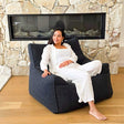 Contemporary living room featuring the Black Bouclé Serena modern bean bag chair with adult seated.