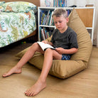 Tan 100% Cotton Canvas Mini Triangles indoor bean bag by Mooi Living, styled indoors, a young boy seated and reading.