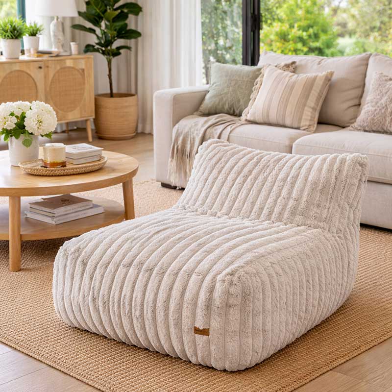 Brooklyn Luxe Lounger Foam Filled Bean Bag in Corduroy Faux Fur by Mooi Living on timber flooring in a modern living room.