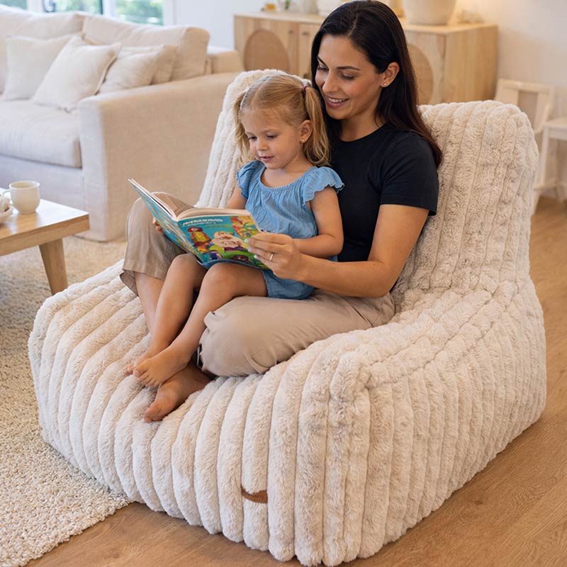 Brooklyn Luxe Lounger Foam Filled in Corduroy Faux Fur by Mooi Living in a living room setting, mother and toddler reading.