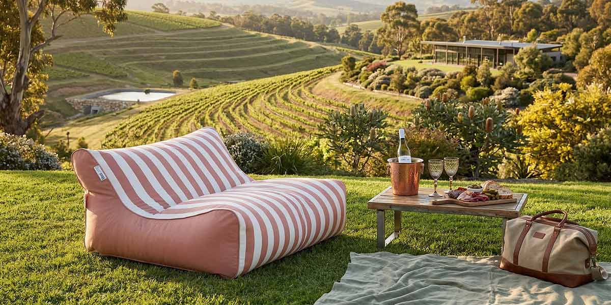 Lifestyle Image - Blush Stripe Chill UV Double Seater Bean Bag located at an Australian winery.