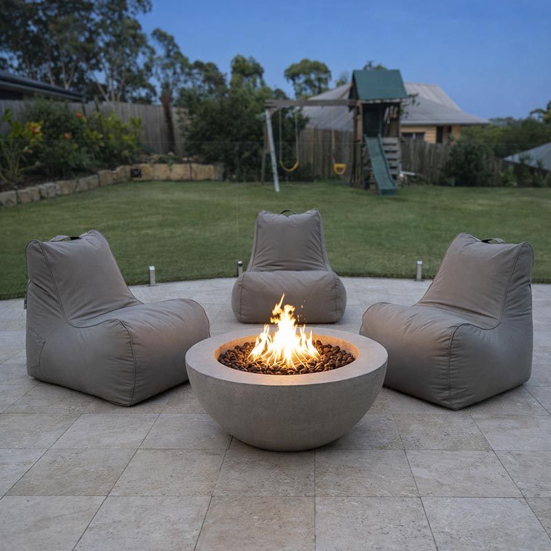 Three Stone Bora Bora Bean Bag Chairs by Mooi Living arranged around an outdoor firepit in an Australian backyard at night.