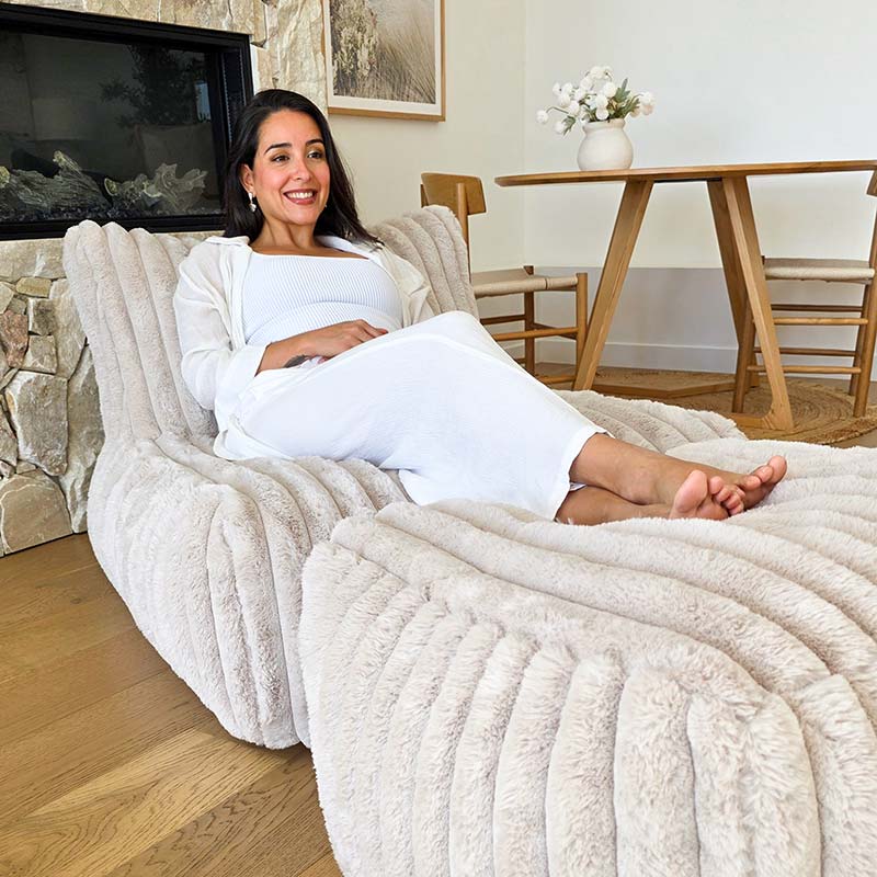 Brooklyn Luxe Lounger Foam Filled in Corduroy Faux Fur by Mooi Living with matching ottoman in a living room setting.
