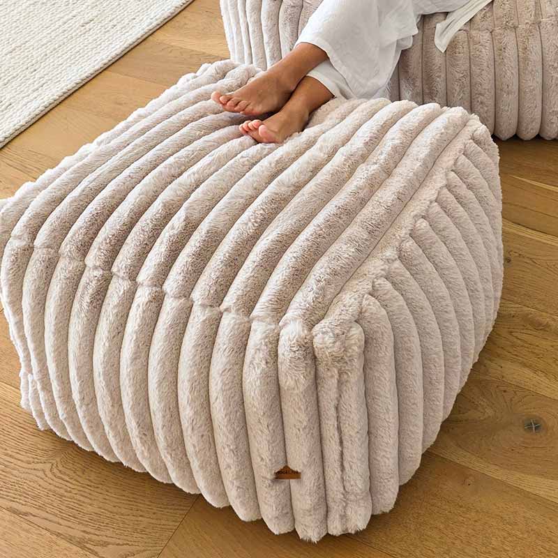 Top view of the textured corduroy Callie ottoman by Mooi Living placed in a contemporary living space.