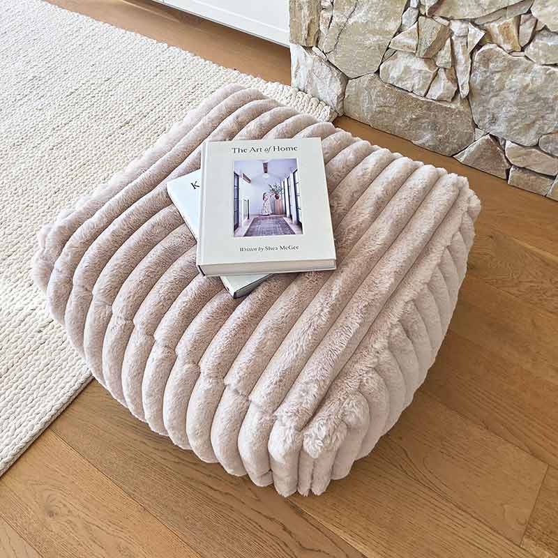 Textured corduroy Callie ottoman by Mooi Living placed in a contemporary living space.