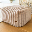 Callie Corduroy Ottoman indoor bean bag by Mooi Living in ribbed cord fabric, styled as a footrest in a modern interior.