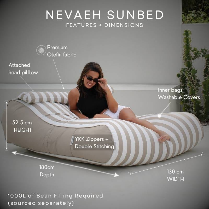 A Nevaeh Sunbed outdoor bean bag in taupe and white stripes, shown with a woman reclining on it. The image includes dimension labels and text callouts for height, width, and depth, plus feature notes such as premium Olefin fabric, attached head pillow, inner bags washable covers, and YKK zippers.