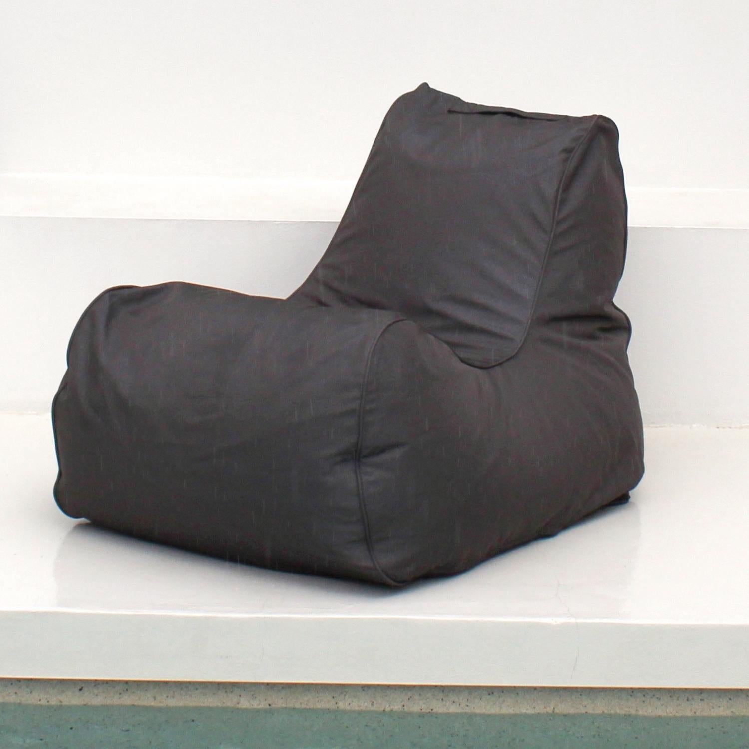 An Oyster Black Outdoor Olefin fabric bean bag chair with a high backrest, sitting on a white platform against a white wall, MOBORABB-OYSBLA