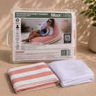 Folded Outdoor reversible triangle bean bag cover in Blush/ blush stripe and inner bag in a Mooi Living packaging.