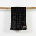 Black textured blanket with a Mooi Living brand 
