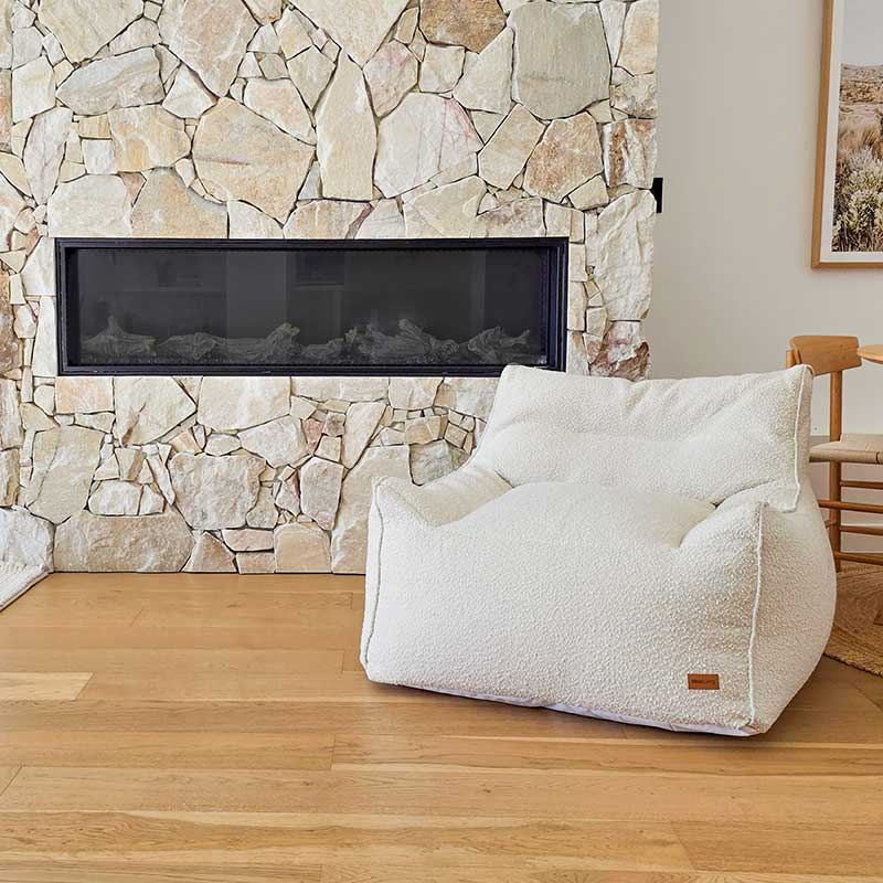 Cream Bouclé Serena Armchair Bean Bag by Mooi Living in a light-filled living room,
