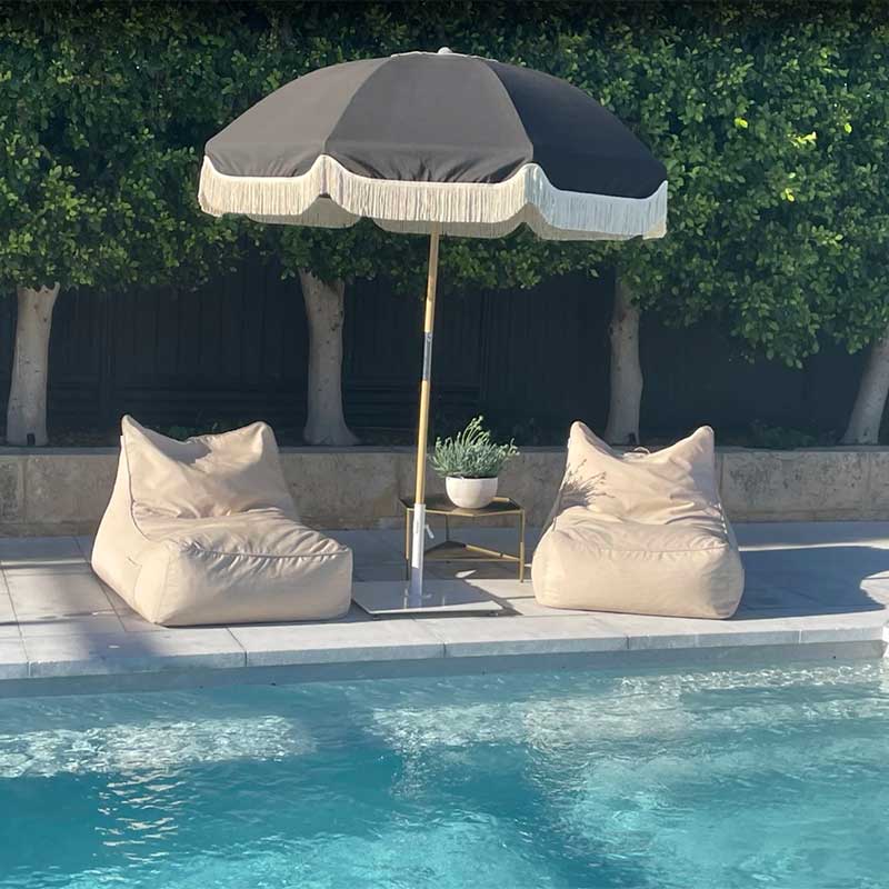 Customer pic by Kate Farmer of two of our Taupe Lachlan Loungers outdoor bean bag by Mooi Living by  her poolside with an umbrella