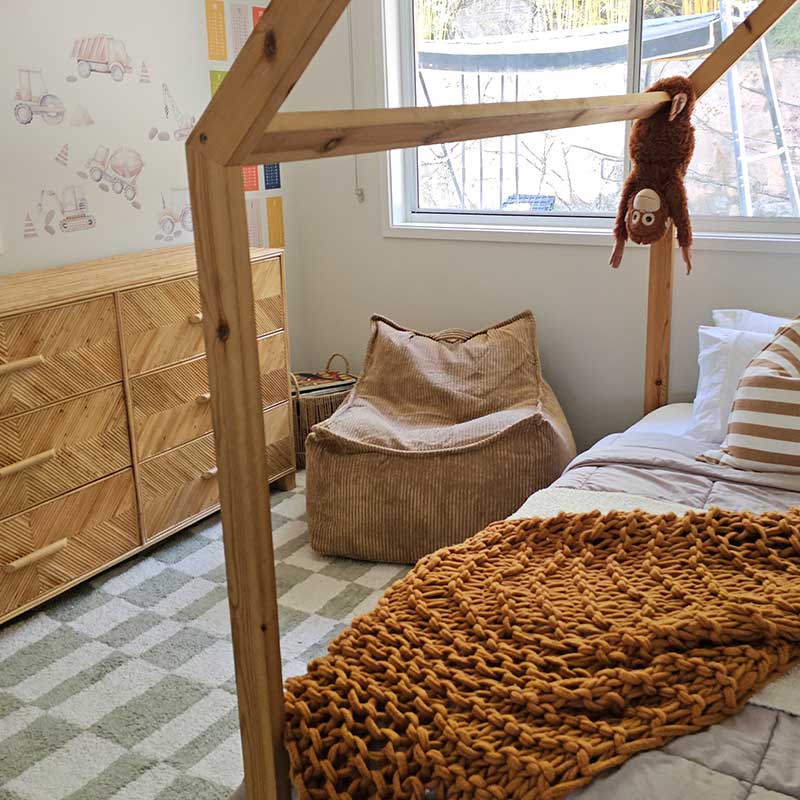 Mini Cord Bean Bag Chair indoor bean bag by Mooi Living in Caramel in a kid's bedroom. This bean bag chair is the perfect spot for kids to play, read books, or relax after a day full of activities.