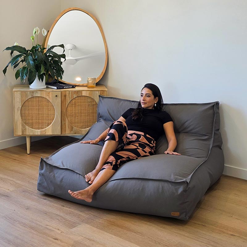 Oversized Mocha Double Boss indoor bean bag by Mooi Living with structured back support and removable cover, woman seated.