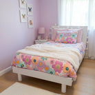 Children's bedroom with a bed featuring a pink faux fur throw