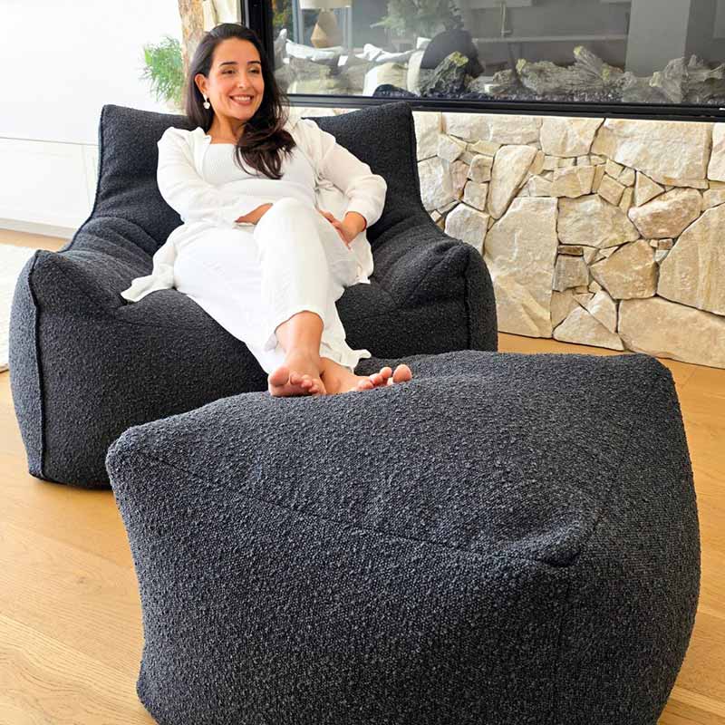 Mooi Living Serena Armchair in textured black bouclé paired with matching ottoman.