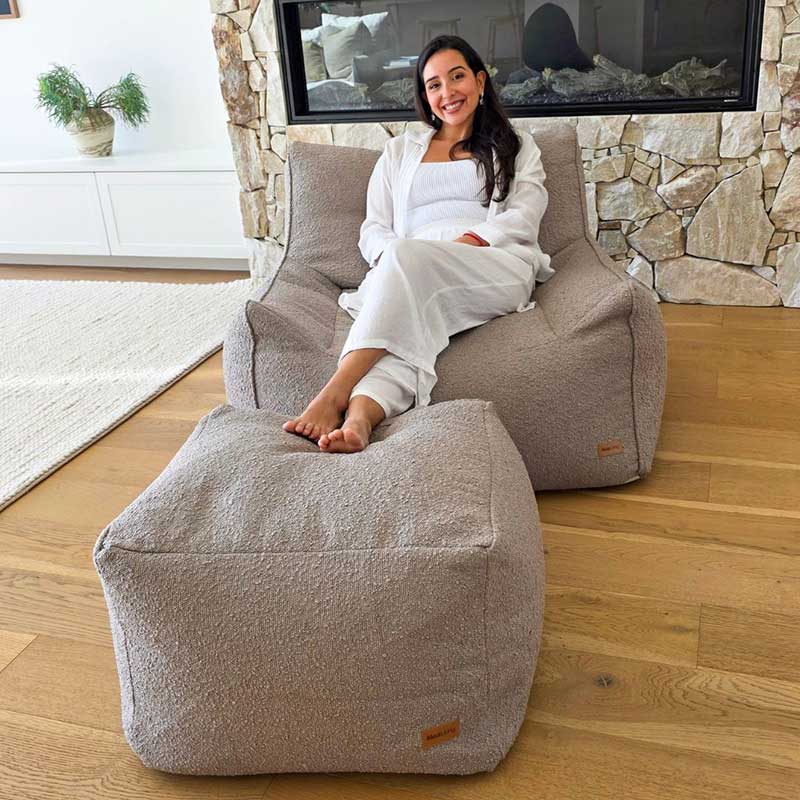 Serena bouclé armchair in Taupe by Mooi Living with separate coordinating ottoman.